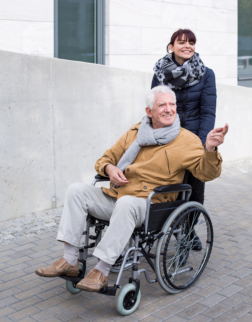 Image of Man in wheelchair and woman helping him